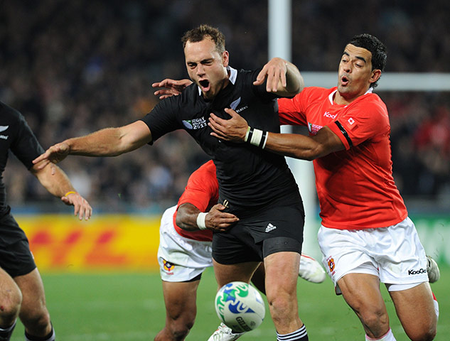 RWC game 1: All Blacks full-back Israel Dagg is tackled by Tonga's fly-half Kurt Morath
