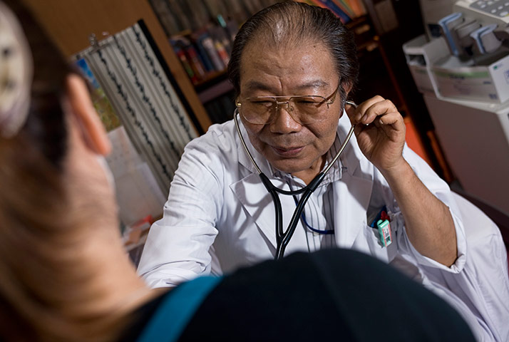 Return to Fukushima: Dr Kyohei Takahashi examines a patient at his clinic, Minamisoma, Fukushima