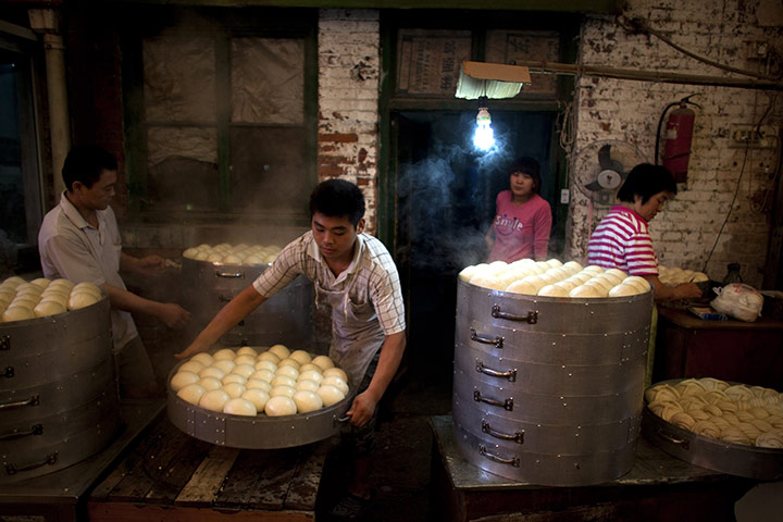 24 hours in pictures: Beijing, China: Vendors prepare steamed buns