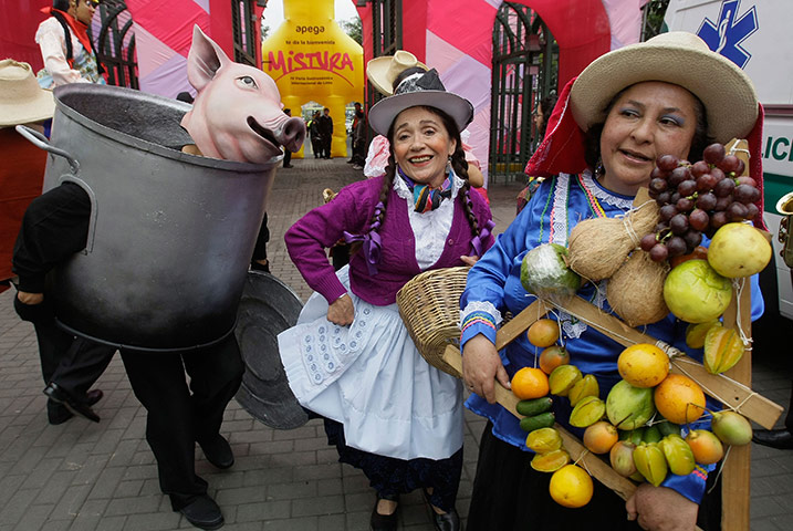 24 hours in pictures: Lima, Peru: Actors perform during the International Gastronomic Fair