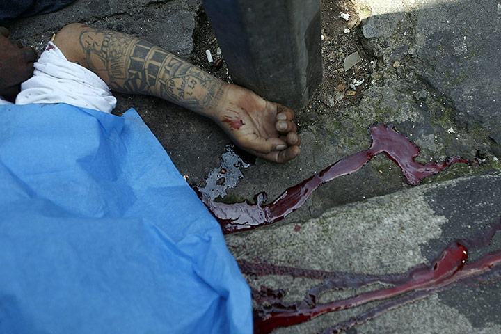 24 hours in pictures: Guatemala City, Guatemala: An alleged gang member after a shooting
