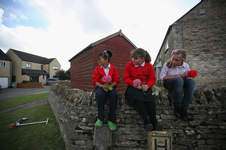 24 hours in pictures: Brize Norton, UK: Children wait for the coffin of Sargeant Weston