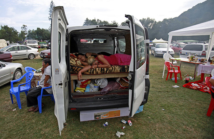 24 hours in pictures: Costesti, Romania: Two Roma women sleep inside a van