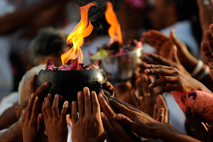 24 hours: Kelaniya, Sri Lanka: Buddhist devotees offer prayers at a temple