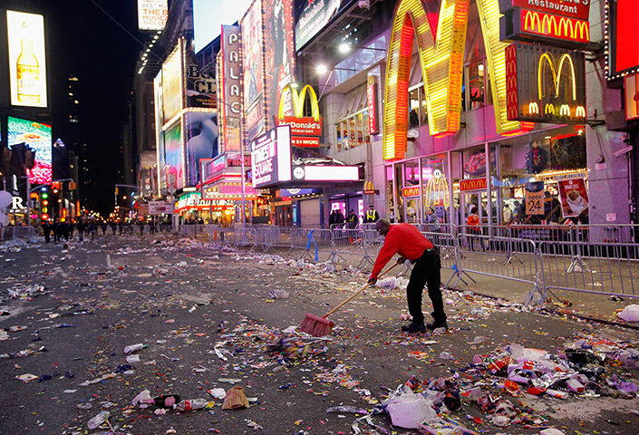 24 hours: New York, USA:  Workmen begin cleaning up in Times Square, New Year's eve
