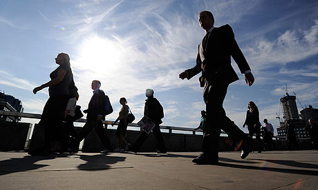 Workers cross London Bridge during the morning rush-hour
