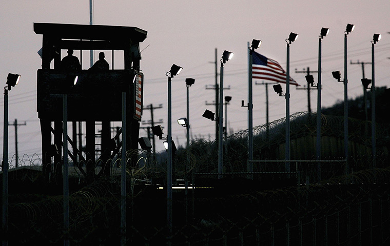 Inside Guantanamo: Members of the US Military stand watch in a guard tower at Camp Delta 