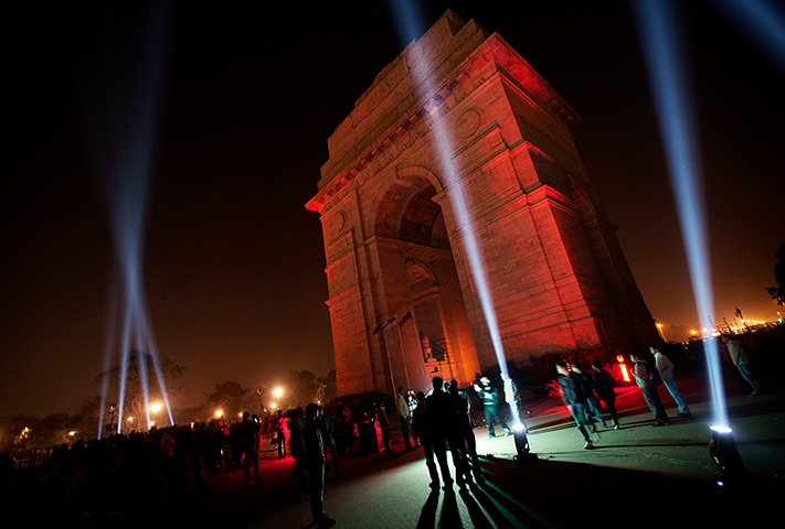 24 hours in pictures: Indians watch a laser light show on the India Gate Monument