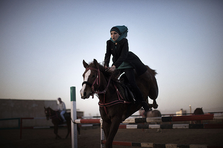 24 hours in pictures: Palestinian woman rides her horse at the Al-Furusia riding centre, Gaza
