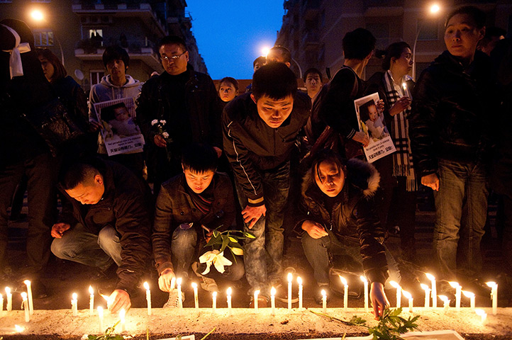 24 hours in pictures: Chinese people in Italy light candles to honour a man killed in Rome