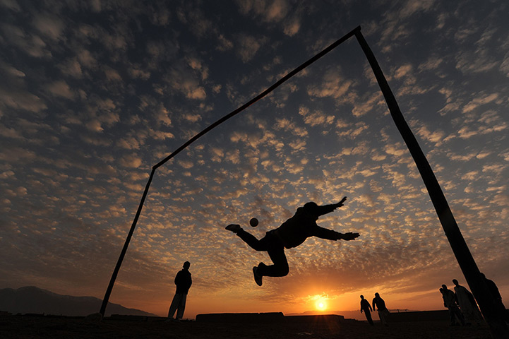 24 hours in pictures: Afghan boys play football in sunset in Mazar-i-Shraif