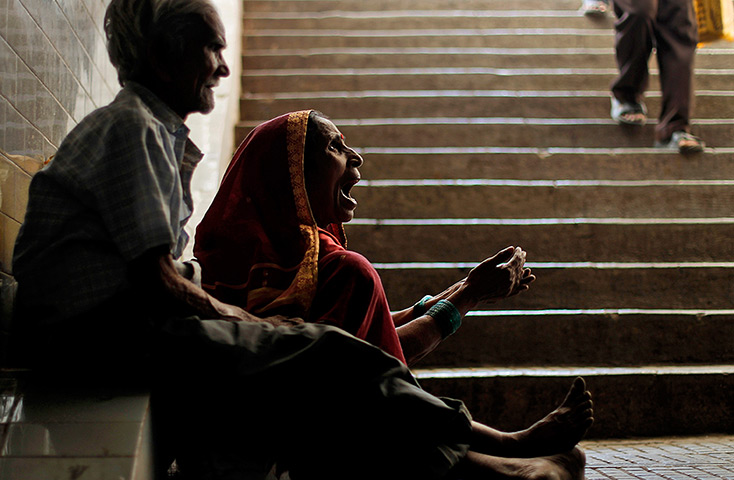24 hours in pictures: A woman begs in a subway in Mumbai, India