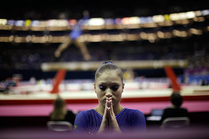 24 hours in pictures: Brazilian gymnast prays infront of beam at Olympic qualifications