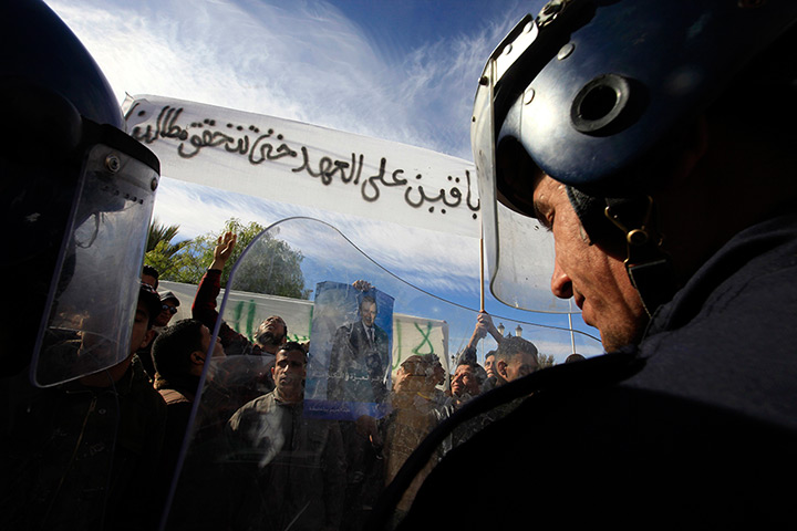 24 hours in pictures: Riot police stand guard as people protest in the Algerian town of Laghouat