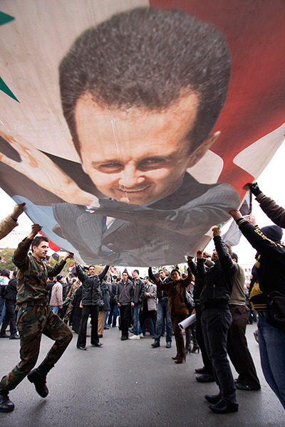 24 hours in pictures: Pro-Syrian protesters wave a giant portrait Bashar Assad