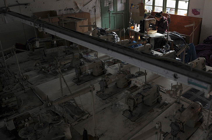Week in business: An employee works at a garment factory in Wuhu