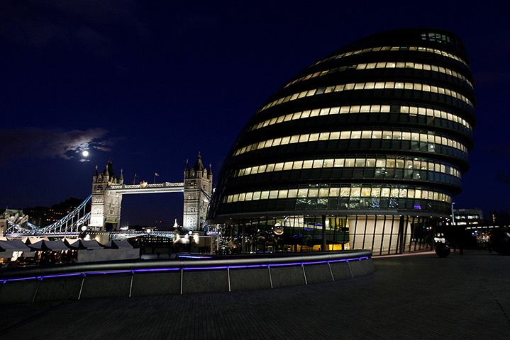 Week in business: Tower Bridge, left, and City Hall, are seen illuminated 