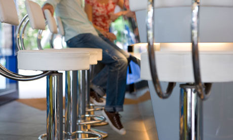 A couple sitting on bar stools