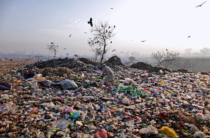 24 hours: Islamabad, Pakistan: An elderly Pakistani man searches a rubbish tip