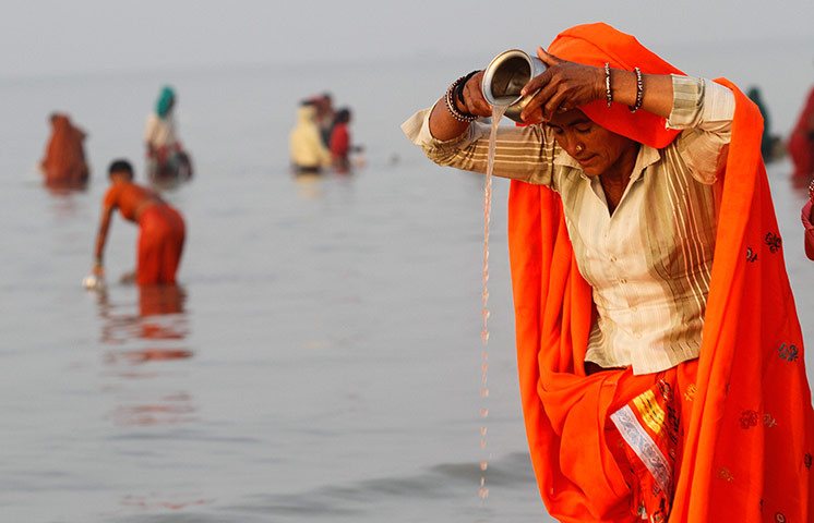 24 hours: Sagar Island, India: A female Hindu pilgrim offers prayers