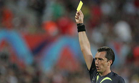 Referee showing yellow card