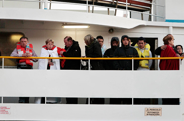 Cruise Aground: Passengers of the Costa Concordia arrive on a ferry in Porto Santo Stefano