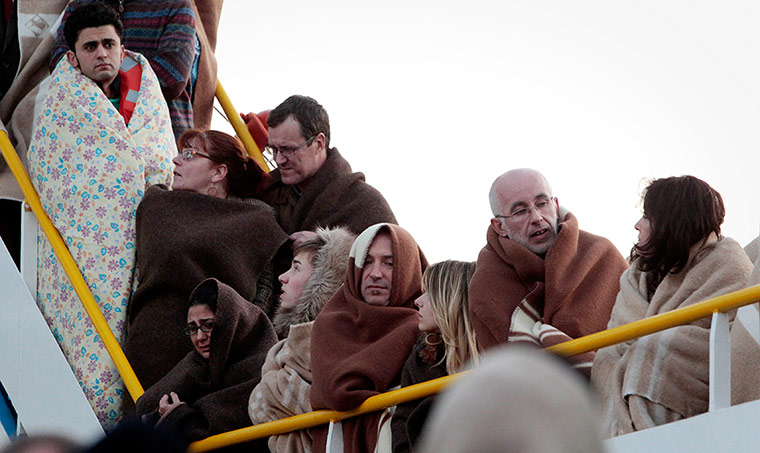 Cruise Aground: Passengers from the ship Costa Concordia on a ferry in Porto Santo Stefano