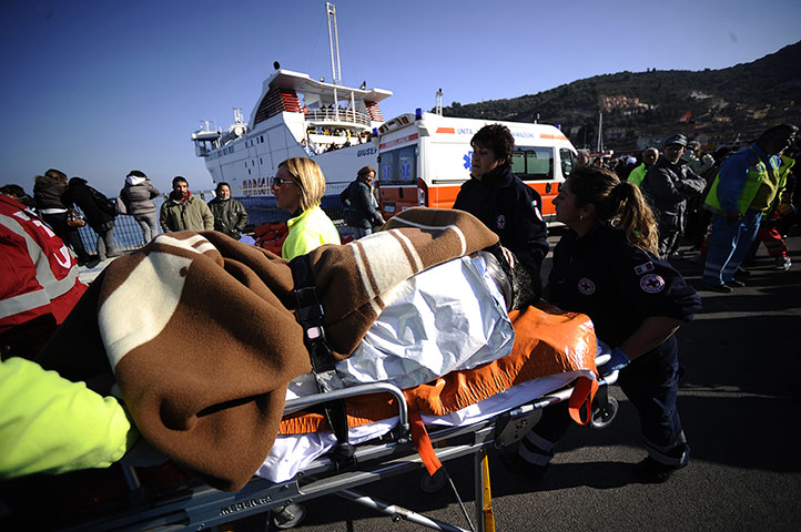 Cruise Aground: A victim of the Costa Concordia on a stretcher at Porto Santo Stefano