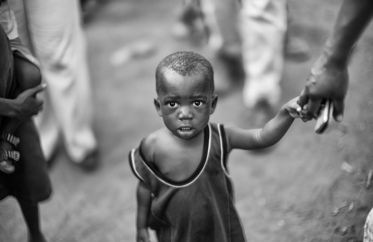 Bono visits Ghana: A young boy in a village visited by Bono and Jeffrey Sachs