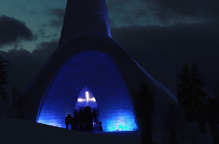 24 hours in pictures: Visitors stand inside a church made entirely of snow and ice, Germany