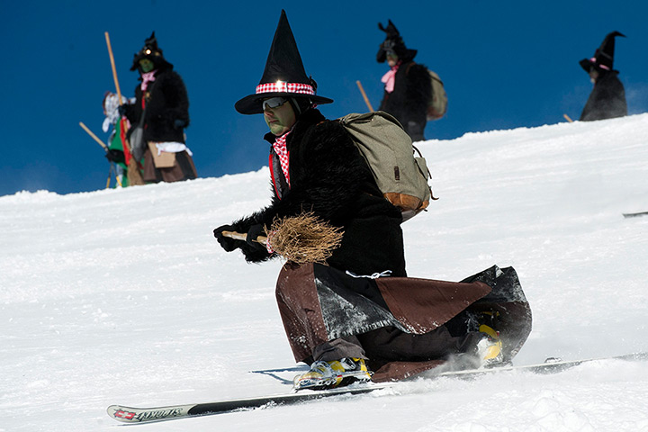 24 hours in pictures: A group of skiers disguised as witches, Switzerland