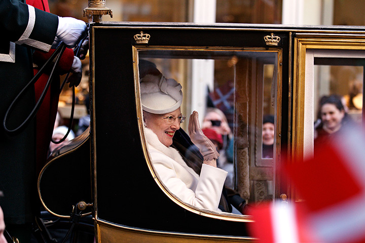 24 hours in pictures: Danish Queen Margrethe waves while riding in a horse drawn carriage