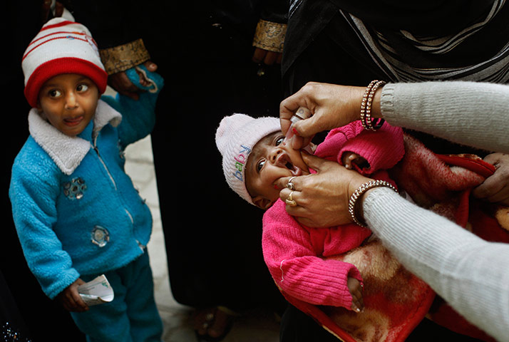 Polio vacination: An infant is given her first polio vaccination at a health camp 