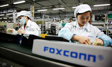 Employees work on the assembly line at the Foxconn plant in Shenzhen, China