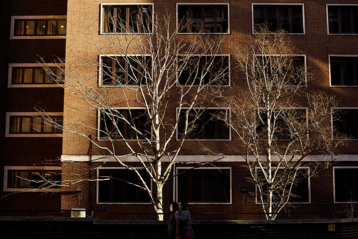 24 hours: London, England: Pedestrians are illuminated by reflections from a building