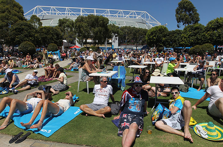 Autralian Open Roundup: Tennis fans watch a match on a big screen Australian Open 2012