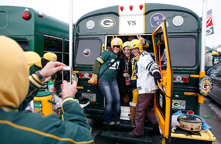 NFL Roundup: Packers fans pose during a tailgating party outside Lambeau Field