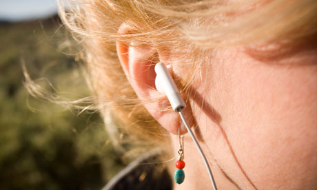 A headphone inserted into a woman's ear The US study concluded that wearing 