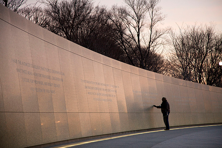martin luther king day: A woman touches a quote on the Martin Luther King Memorial in Washington