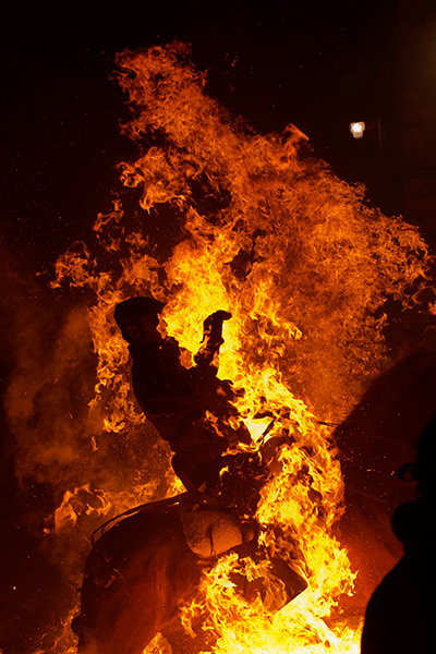 Luminarias, Spain: A man rides a horse through a bonfire