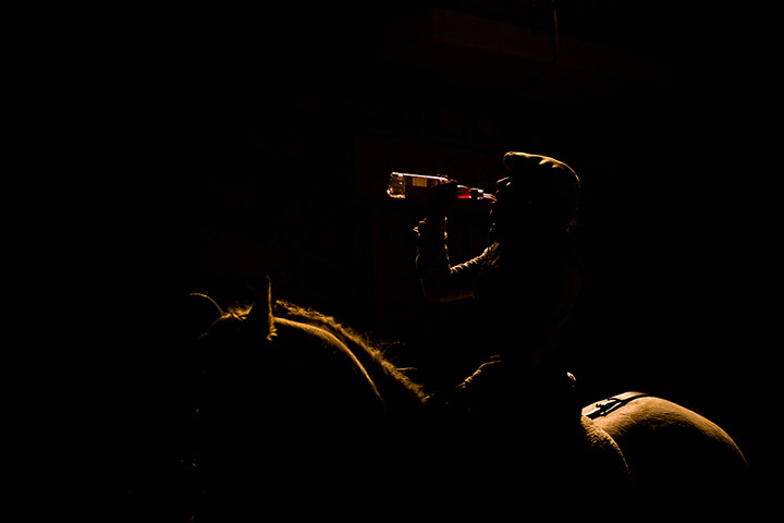 Luminarias, Spain: A woman drinks after riding her horse