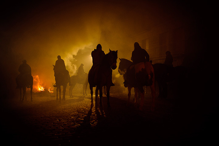 Luminarias, Spain: Revelers ride their horses near the bonfires
