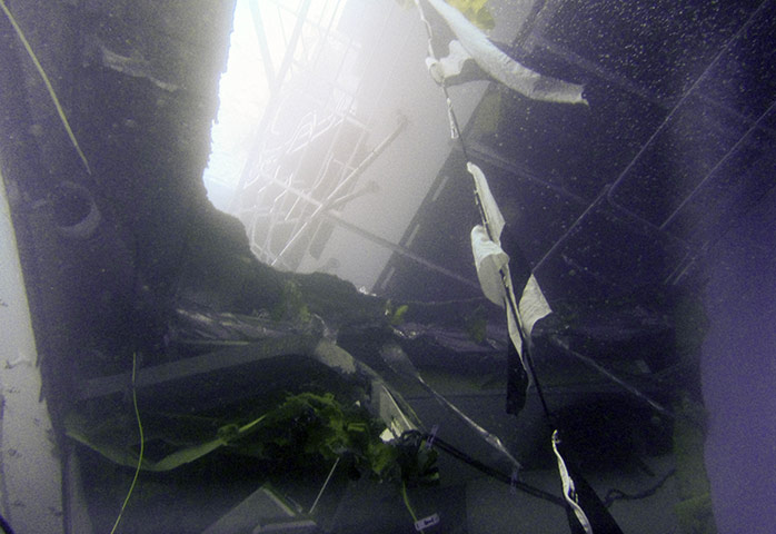 Costa Concordia: Daylight shines through a hole in the superstructure