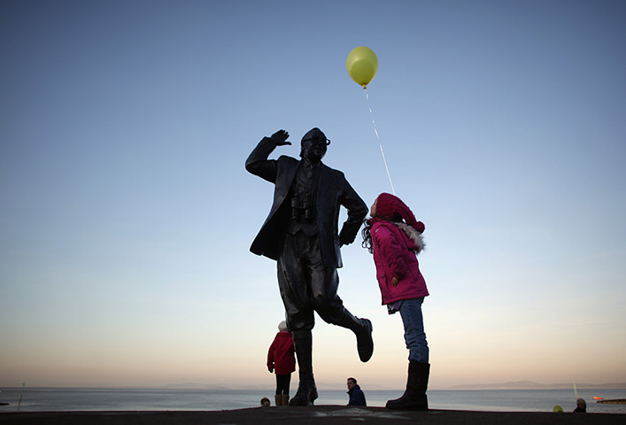 24 hours in pictures: Morecambe, UK: Children play beside the statue of Eric Morecambe