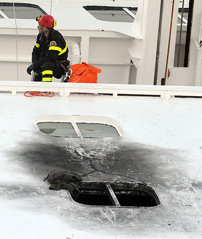 Rescue efforts continue: A fireman searches above the point where navy commandos used explosives