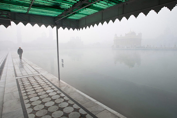 24 hours in pictures: A Sikh man walks by the sacred pond of the Golden Temple 