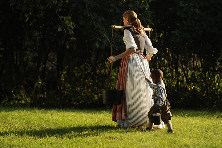 FTA: Michael Reynolds: A re-enactor carries water with a child at the Cascades Civil War Muster