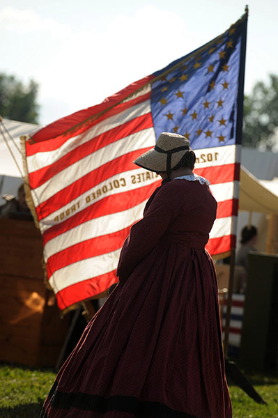 FTA: Michael Reynolds: A Civil War reenactor in front of the flag of the 102nd US Colored Troop