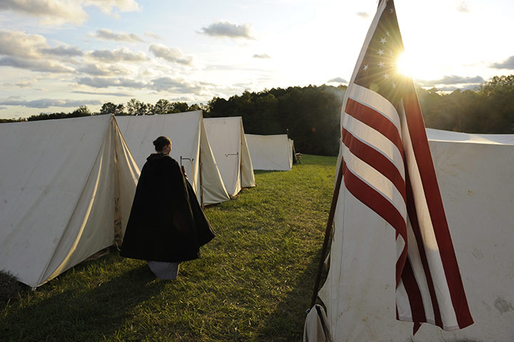 FTA: Michael Reynolds: A reenactor portraying the wife of a Union soldier walks through camp