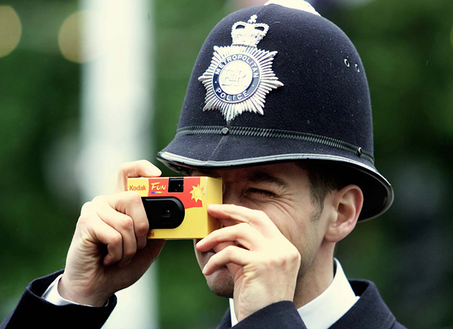 Kodak: 4 June 2006: A policeman takes a picture with a Kodak disposable camera